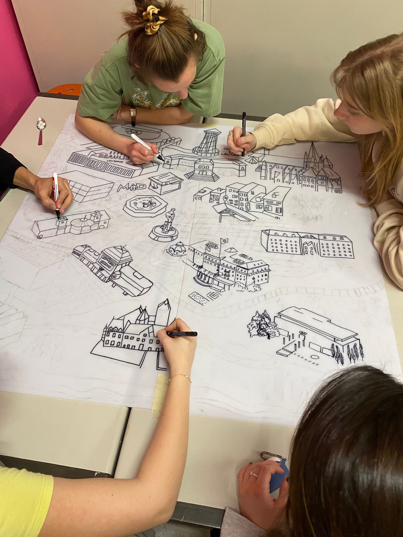 CANVAS students sketching a collaborative plan of Lausanne together